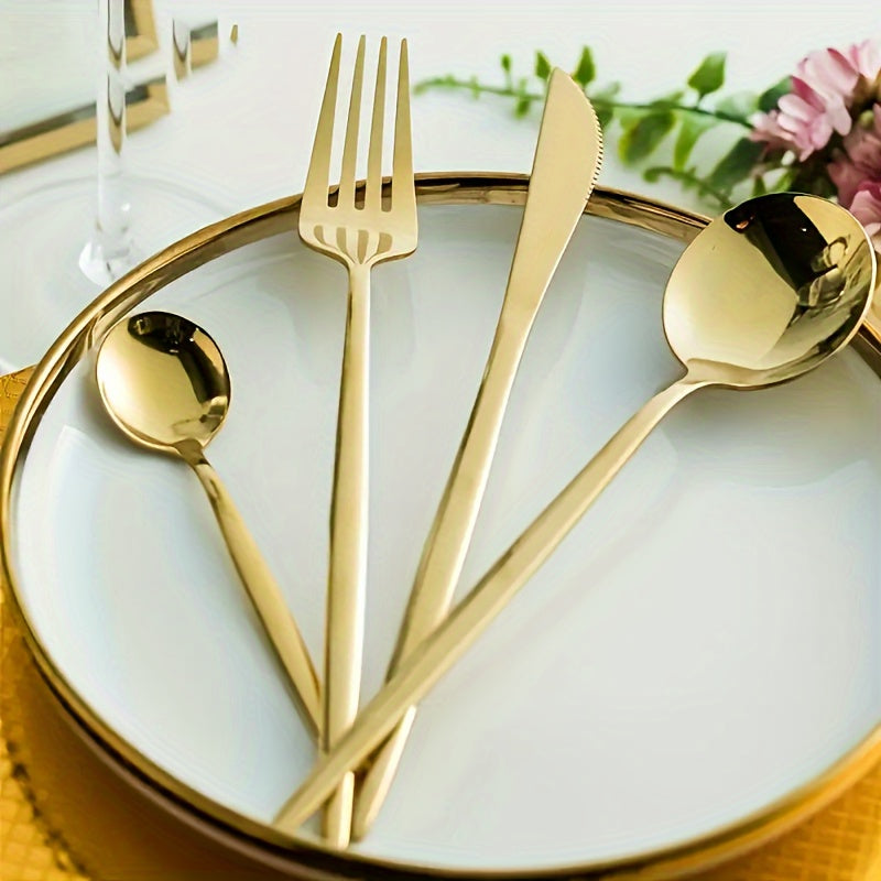 Gold cutlery set on a white plate with a decorative background