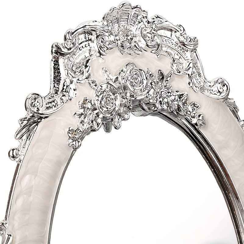 Elaborately designed silver ring with floral and scroll patterns on a white background