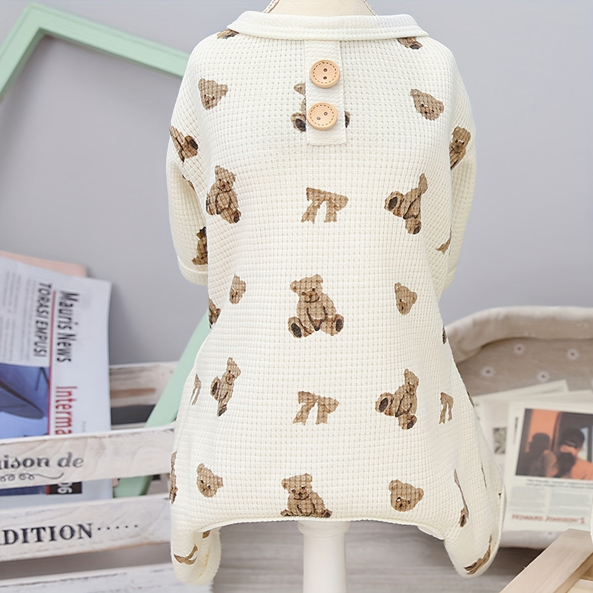 Baby romper with bear pattern on a mannequin against a neutral background