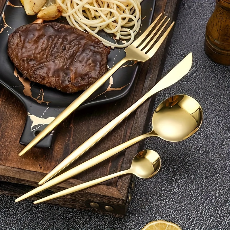 Gold cutlery set on a dark surface with a steak and pasta dish in the background