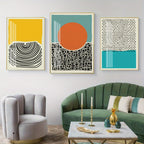 Modern living room with abstract art on the wall and a green sofa.