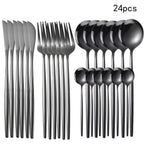 Set of 24 black flatware pieces including knives, forks, and spoons on a white background.