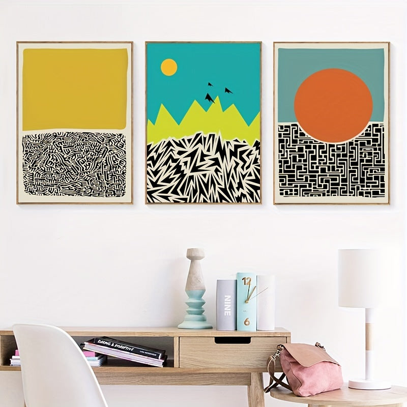 Three abstract art prints on a wall above a wooden shelf with decor items.