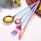 Set of colorful cutlery including a spoon and fork on a white surface.