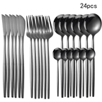 Set of 24 black flatware pieces including knives, forks, and spoons on a white background.
