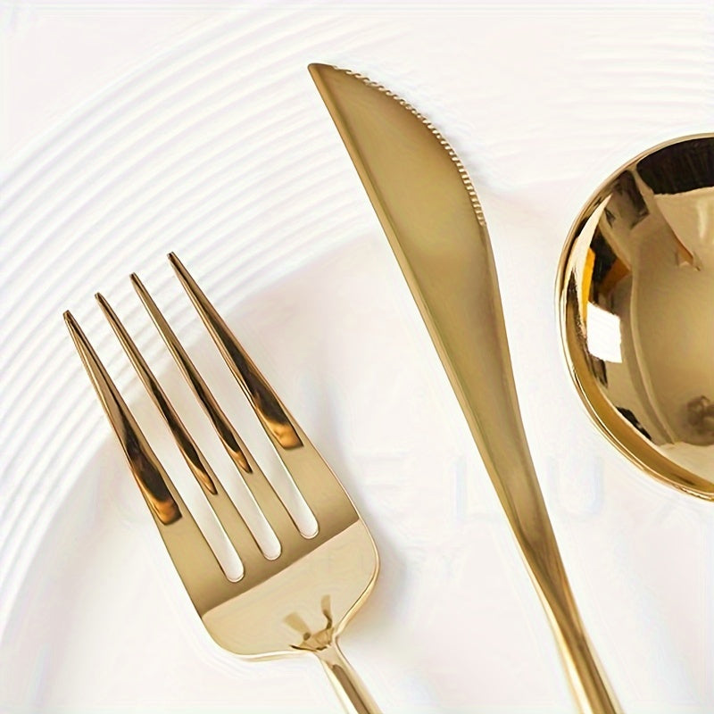 Gold fork and knife set on a white plate