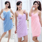 Three women wearing colorful towel dresses against a white background