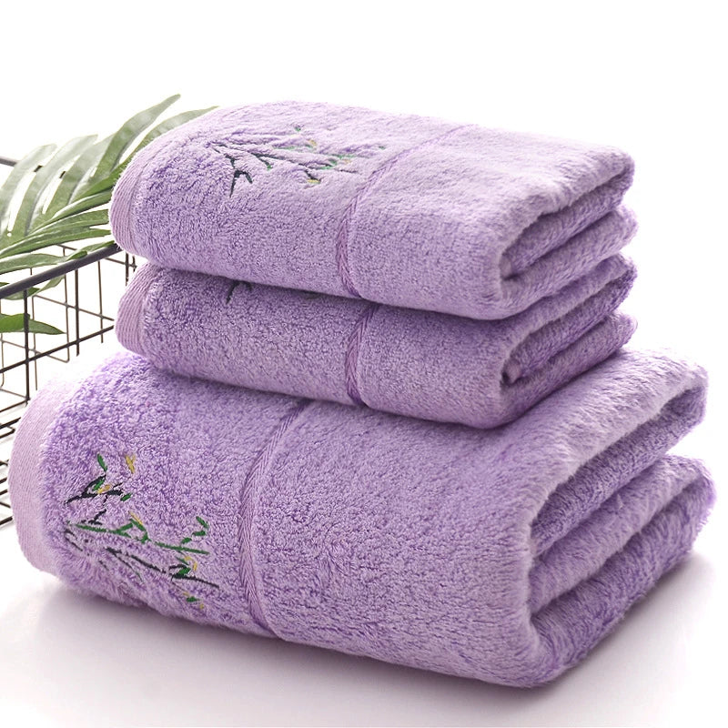 Stack of purple towels with embroidery on a white background