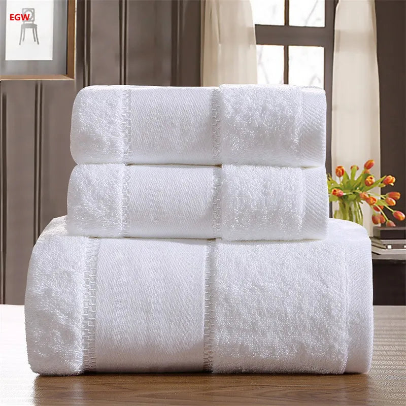Stack of white towels on a wooden surface with a blurred background