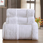 Stack of white towels on a wooden surface with a blurred background