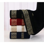Set of folded towels with decorative patterns on a white background