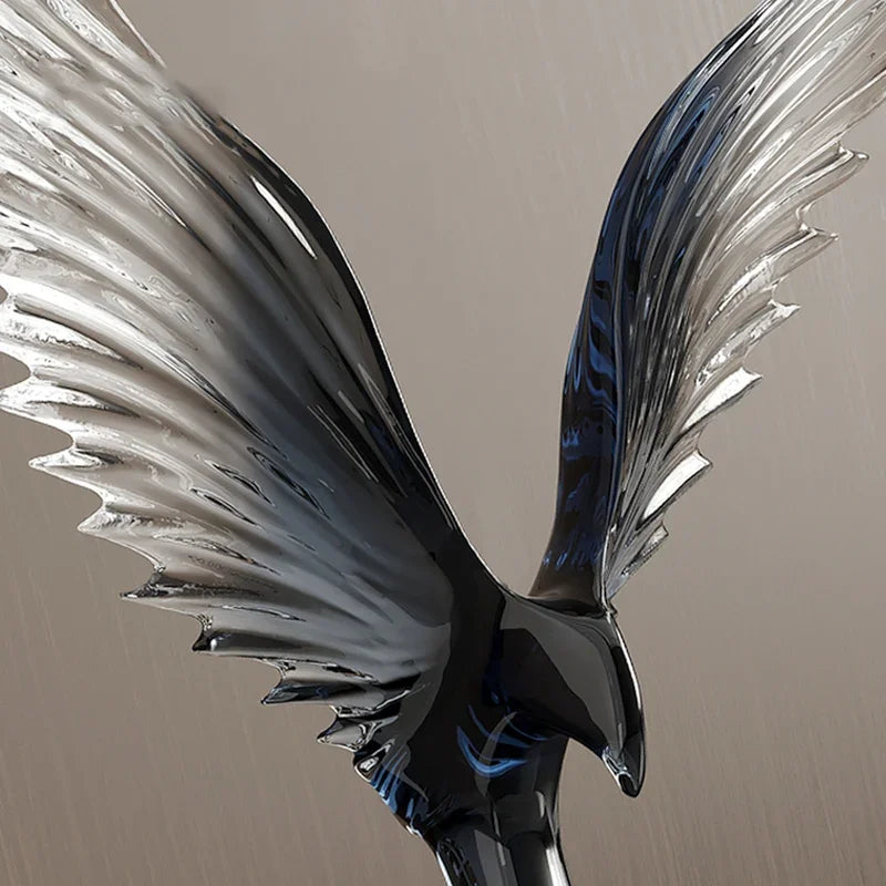Metallic wing-like sculpture on a beige background