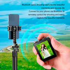 Handheld device with screen displaying a person in a field, connected to a smartphone via Bluetooth, with scenic background.