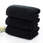 Stack of black towels on a white background