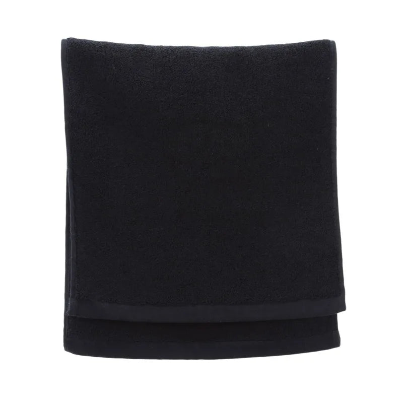 Folded black blanket on a white background