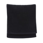 Folded black blanket on a white background