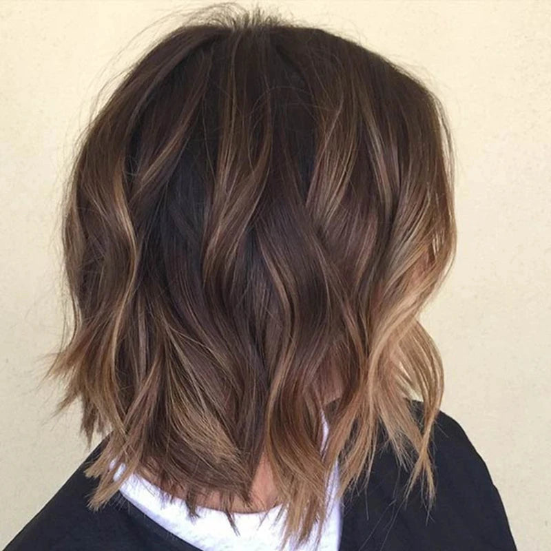 Close-up of wavy brown hair with highlights on a plain background