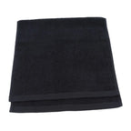 Folded black towel on a white background