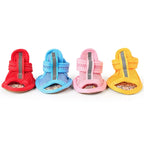 Four colorful pet shoes on a white background