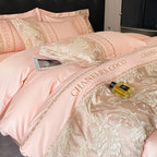 Pink bedding set with floral patterns and 'CHANEL'S COCO' branding, featuring a bottle of perfume.
