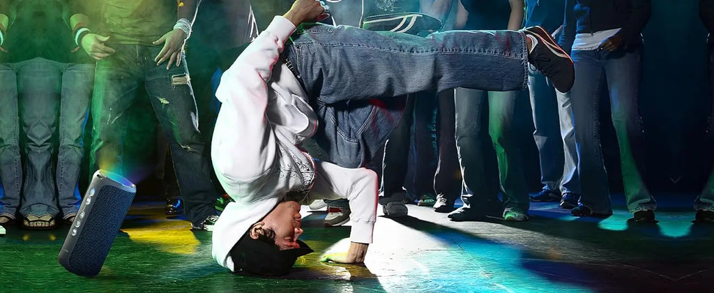 erson breakdancing on a stage with a crowd in the background