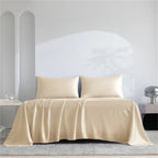 Beige satin sheet set on a bed with a neutral background