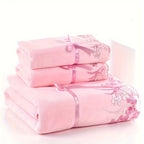 Set of pink towels with lace details on a white background