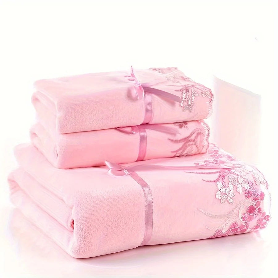 Set of pink towels with lace details on a white background