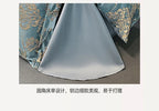 Silky fabric with floral embroidery on a plain background