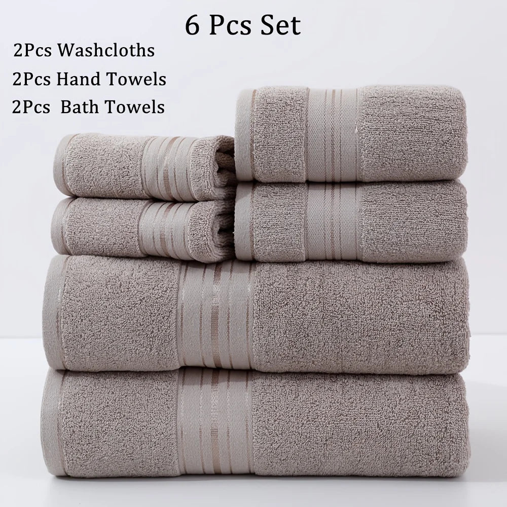 Set of six towels including washcloths, hand towels, and bath towels stacked on a white background.
