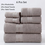 Set of six towels including washcloths, hand towels, and bath towels stacked on a white background.