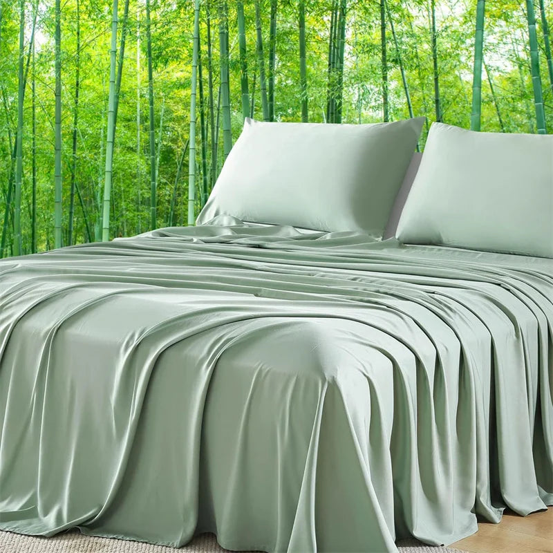 Green satin sheet set on a bed with a forest background