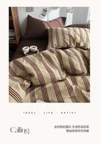 Striped bedding set on a bed with a neutral color scheme
