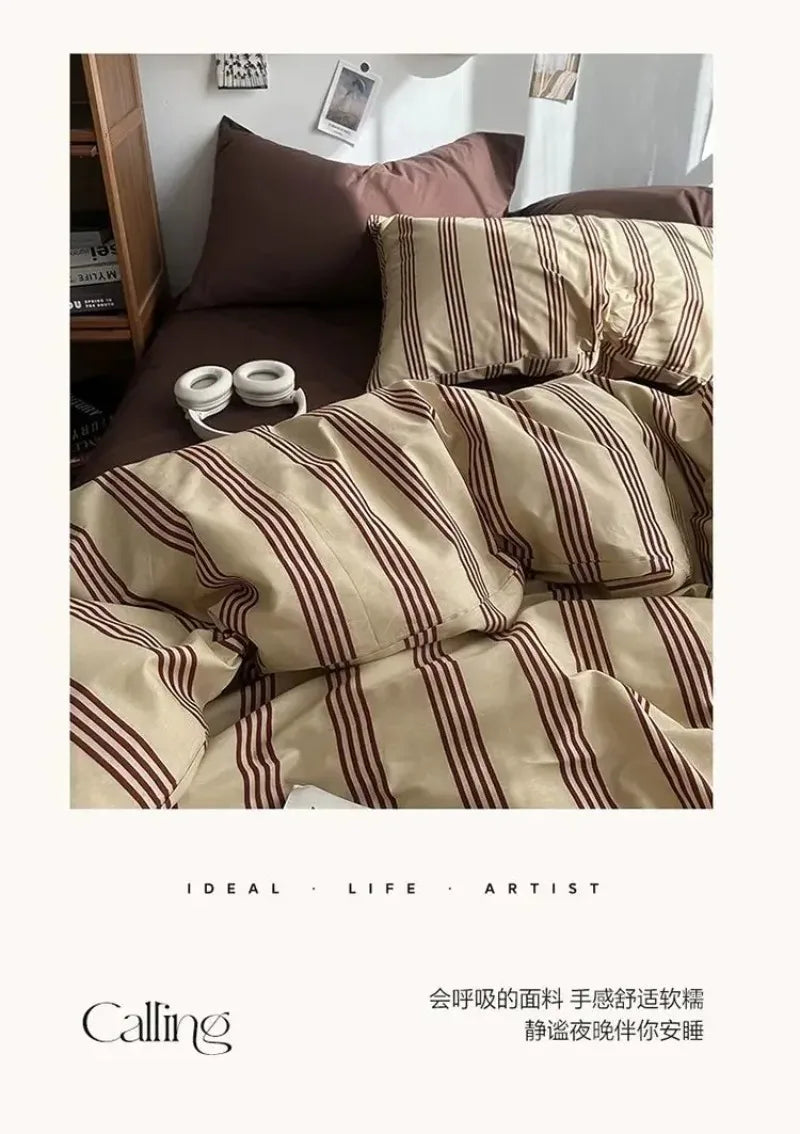 Striped bedding set on a bed with a neutral color scheme