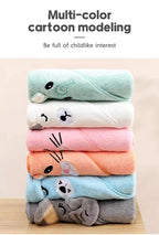 Stack of colorful cartoon-themed towels on a wooden surface with text above.