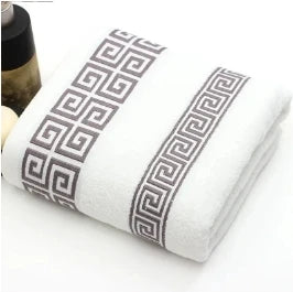White towel with black geometric pattern on a white background