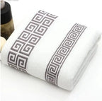 White towel with black geometric pattern on a white background