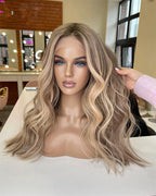 Blonde wig on a mannequin head with a salon setting in the background