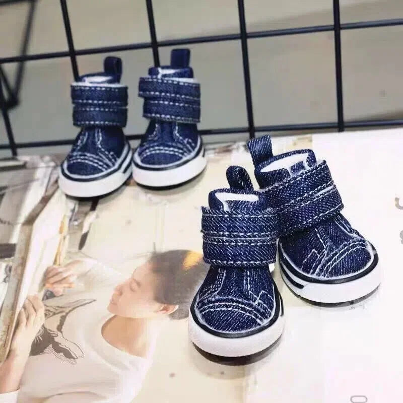 Pair of blue children's shoes with white soles on a magazine background