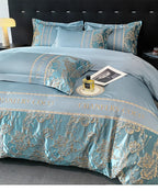 Luxurious blue and gold bedding set with 'Chanel' branding on a bed.