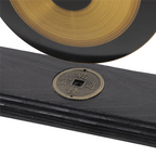 Black leather-bound book with a brass plate featuring East Asian characters on a white background