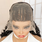 Mannequin head with a wig and face veil against a neutral background