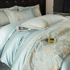 Luxury light blue bedding set with gold embroidery on a bed.