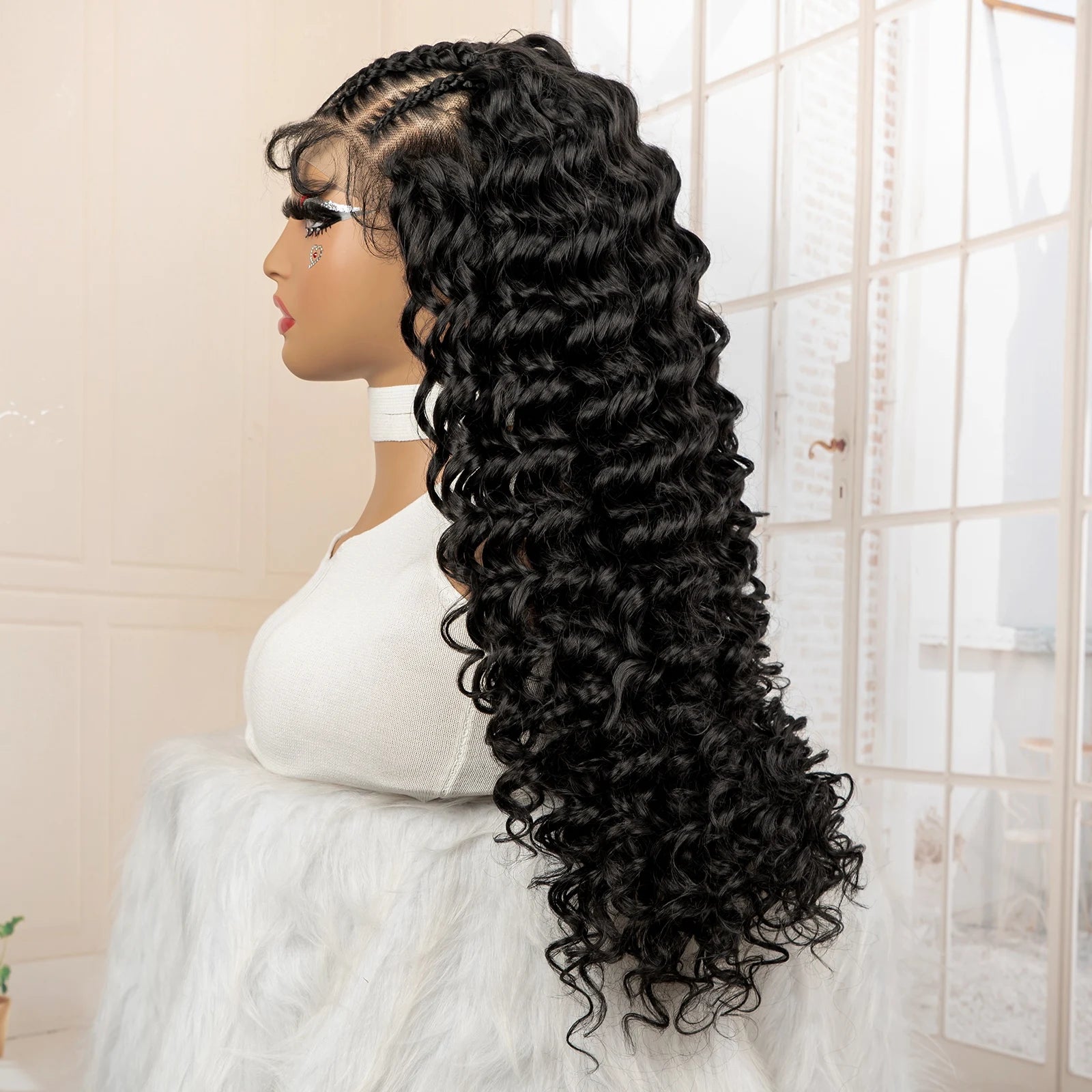 Mannequin head with a long black curly wig in a neutral setting