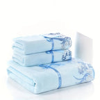 Stack of light blue towels with floral patterns on a white background