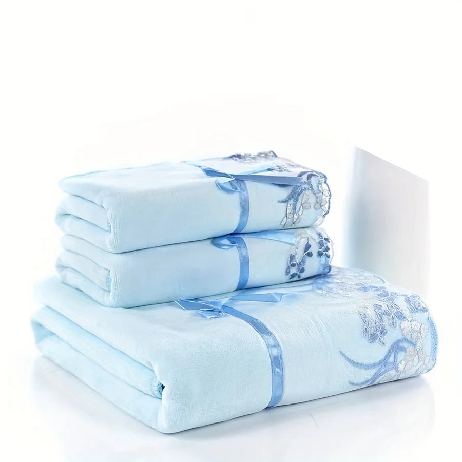 Stack of light blue towels with floral patterns on a white background