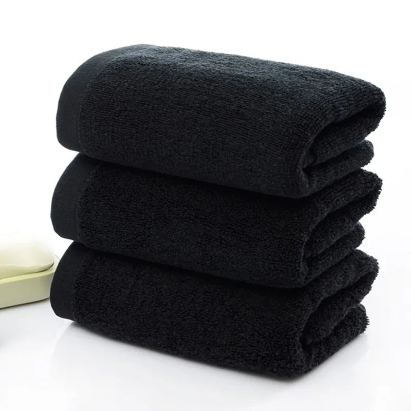 Stack of black towels on a white background
