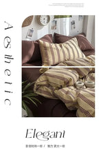 Cozy bedroom with striped bedding and pillows, featuring the brand 'Elegani'.