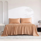 Beige bedspread and pillows on a bed in a minimalistic room.