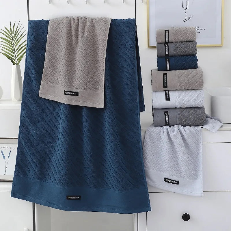 Set of blue and gray towels with a brand label on a white background